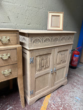 Load image into Gallery viewer, Beautifully stripped oak hi-fi unit in excellent structural condition. The hinged top opens to reveal generous record storage, while the double cupboard features a practical drawer below. Natural finish may benefit from a protective wax coat to enhance the wood grain and ensure longevity. A versatile piece for vinyl enthusiasts and vintage audio collectors.

Delivery Available

Overall Dimensions

74cm wide x 48cm deep x 88cm high


