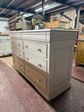 Load image into Gallery viewer, A handsome mahogany chest of drawers in the classic Louis Philippe Sleigh style. Features 6 spacious long drawers beneath 2 concealed drawers, offering generous storage for bedroom or hallway. Vintage condition with honest wear marks that add character. Structurally sound and ready for use. An elegant period piece with authentic charm. RRP £995

Delivery Available

Overall Dimensions

150cm wide x 55.5cm deep x 91cm high

