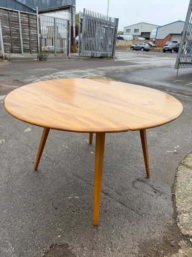 This beautiful blonde mid-century Ercol dining table is solidly built and well-maintained. It shows only slight marks that are hardly visible. Easily extendable, it comfortably accommodates 4 to 5 people.

Delivery Available

Overall Dimensions

103cm x 62cm x 71cm high 

126cm extended      
