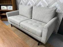 Load image into Gallery viewer, This beautiful 3 seater grey fabric sofa is practically new and offers both style and comfort. Its sturdy frame ensures long-lasting use, while the soft grey fabric adds a touch of elegance that complements any room decor. The neutral shade makes it easy to match with your existing furniture and accessories. For added convenience, the legs can be removed, making it simpler to move and fit through doorways. Perfect for relaxing with family or entertaining guests, this sofa combines practicality with a cheerf

