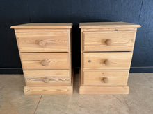 Load image into Gallery viewer, A charming pair of stripped pine bedside tables, each featuring three dovetail-jointed drawers for practical storage. Structurally sound with good overall condition, these vintage pieces show honest wear consistent with their age—minor marks add to their character. Ideal for period homes or those seeking authentic, functional bedroom furniture with traditional craftsmanship.

Delivery Available

Overall Dimensions

47cm wide x 39cm deep x 65.5cm high&nbsp;


