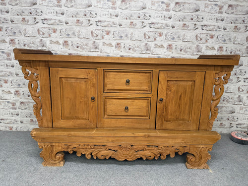 This beautiful Indonesian carved sideboard is sturdy and generally well-preserved. While there are a few marks on the top and some minor wear on the skirt, these do not detract from its charm. It offers plenty of storage space with two dovetail-jointed drawers and two cupboards, each featuring a shelf. This piece is sure to brighten up any room and become a standout feature.

Overall Dimensions

161cm wide x 60.5cm deep x 89cm high

DELIVERY AVAILABLE      

For our other items see our website https://fosse