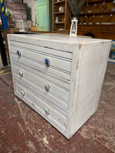 Load image into Gallery viewer, A practical wooden chest featuring three spacious drawers ideal for bedroom or living room storage. This pre-loved piece shows honest signs of age with surface marks, but remains structurally solid and fully functional.&nbsp;

Delivery Available

Overall Dimensions

87.5cm wide x 48.5cm deep x 75cm high
