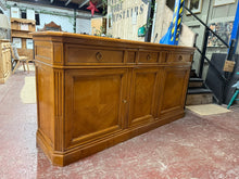 Load image into Gallery viewer, This impressive Italian Selva cherry wood sideboard combines timeless craftsmanship with practical storage. Structurally sound and in good condition, it bears the gentle patina of age with only minor marks that add character. Features three dovetail-jointed drawers, two hidden secret drawers, and dual cupboards—one double, one single—offering generous storage for any room. Includes the original key. A substantial piece perfect for those who appreciate vintage furniture with heritage appeal.

Delivery Availa
