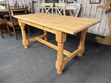 Load image into Gallery viewer, Discover the timeless appeal of this magnificent solid pine refectory table, lovingly restored to reveal its authentic natural beauty. With its raw, unfinished surface ready for your personal touch—whether a protective wax finish or custom stain—this piece becomes uniquely yours. Generously proportioned to comfortably accommodate six diners, it&#39;s the perfect centrepiece for memorable meals and gatherings with family and friends.

Overall Dimensions

149.5cm wide x 76cm deep x 73.5cm high

DELIVERY AVAILABLE
