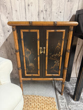 Load image into Gallery viewer, A charming oriental bamboo cupboard with solid construction and authentic character. This pre-loved piece shows gentle signs of use that add to its vintage appeal. Features practical double-door storage, ideal for adding warmth and natural texture to any room. Well-maintained and ready to enhance your home.

Delivery Available

Overall Dimensions

51.5cm wide x 30.5cm deep x 76.5cm high


