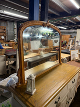 Load image into Gallery viewer, A charming pine over mantle mirror that's built to last, showcasing wonderful architectural details along the top and sides. While it bears the gentle patina of age with minor surface marks, this piece remains in excellent working condition. Perfect for adding character and light to any room, this classic mirror combines solid craftsmanship with timeless appeal.

Overall Dimensions

approx : 125cm wide x 84cm high

DELIVERY AVAILABLE      

For our other items see our website https://fossewayfurniture.co.uk
