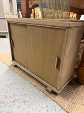 Load image into Gallery viewer, A charming oak veneer cupboard, stripped back to reveal its natural beauty. The authentic finish showcases the wood's character and grain, though a protective coat of wax is recommended to maintain its appearance. Ideal for storing shoes, accessories, or everyday items while adding warmth and character to any room.

Delivery Available

Overall Dimensions

69cm wide x 26.5cm deep x 53.5cm high

