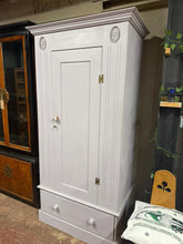 Load image into Gallery viewer, A charming solid pine wardrobe brimming with character and potential. This well-built piece features generous storage space with a full-length hanging rail and a sturdy dovetail-jointed drawer, perfect for organising your wardrobe essentials. Currently finished in a soft lilac tone, it's an ideal candidate for a refresh to match your décor style. Structurally sound and ready for its next chapter, this vintage find comes with its original key and promises years of reliable use.

Overall Dimensions

98cm wide
