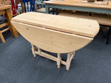 Load image into Gallery viewer, Crafted from solid pine, this gate leg table offers practical flexibility for any dining space. The stripped finish showcases the natural wood grain, though it will benefit from a protective wax coating. When fully extended, it comfortably seats four to six guests, yet folds compactly away for storage when not needed. A versatile piece that adapts to your home's changing requirements.

Delivery Available

Overall Dimensions

extended : 119cm wide x 120cm deep x 75cm high&nbsp;
