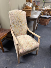 Load image into Gallery viewer, A beautifully restored armchair featuring a solid oak frame stripped to reveal its natural grain and character. The floral upholstery is in excellent condition, complementing the clean lines of the exposed wood. The frame is structurally sound and ready for use, though a protective wax finish would enhance durability and bring out the wood's warmth. An ideal piece for those seeking vintage charm with modern appeal.

Delivery Available

Overall Dimensions

approx : 54cm wide x 62cm deep x 99cm high

