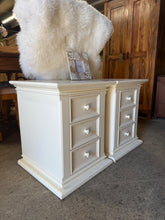 Load image into Gallery viewer, A charming pair of Julian Bowen bedside tables. Each unit features three practical drawers for storage, offering functional bedroom solutions. Both pieces are structurally sound and ready for use, though they show honest signs of age with minor marks and wear. Perfect for those seeking vintage appeal or a restoration project.&nbsp;

Delivery Available

Overall Dimensions

47cm wide x 49cm deep x 58.5cm high

