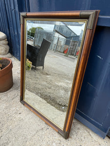 This beautiful bevelled edged mirror features elegant brass corners. It is pre-owned and shows some minor marks, but nothing significant. A hanging wire is attached at the back, making it simple to mount.

Delivery Available

Overall Dimensions

59cm wide x 82cm high
