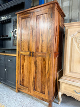 Load image into Gallery viewer, This striking Myakka Sheesham wardrobe combines solid construction with authentic character. Well-maintained with minor cosmetic marks consistent with pre-loved furniture, it offers generous storage with a hanging rail and spacious shelf. A distinctive bedroom focal point that brings warmth and natural beauty to any space.

Delivery Available

Overall Dimensions

89cm wide x 60cm deep x 170.5cm high&nbsp;

