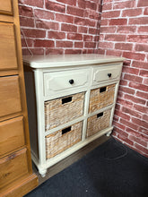 Load image into Gallery viewer, A charming cream bathroom unit that combines style with practical storage. Two smooth-operating drawers sit above four wicker baskets, offering flexible organisation for toiletries and essentials. The unit is structurally sound and in good overall condition, with minor surface marks that reflect its character. Ideal for adding warmth and functionality to any bathroom space.

Delivery Available

Overall Dimensions

76cm wide x 33.5cm deep x 72cm high

