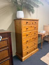 Load image into Gallery viewer, A substantial solid pine chest of drawers offering practical storage across seven dovetail-jointed drawers—two compact drawers at the top and five generous drawers below. Structurally sound with authentic character, this piece shows gentle signs of use consistent with vintage furniture. Ideal for bedrooms or living spaces where you need reliable storage with traditional craftsmanship and natural wood appeal.

Delivery Available

Overall Dimensions

85cm wide x 43.5cm deep x 134cm high

