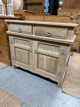 Load image into Gallery viewer, A solid oak sideboard stripped to bare wood, ready for your finishing touch. Features two dovetail-jointed drawers above a spacious double cupboard, offering practical storage for any room. The piece is structurally sound and well-maintained, though you may want to apply wax or oil to protect the wood and enhance its natural grain. A versatile vintage find with genuine craftsmanship.

Delivery Available

Overall Dimensions

93cm wide x 44cm deep x 81cm high&nbsp;


