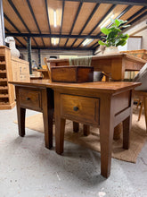 Load image into Gallery viewer, A handsome pair of hardwood lamp tables, both structurally sound and ready for any room. As used pieces, they show honest wear and patina that adds character—minor marks reflect their history. Each table features a dovetail-jointed drawer, offering practical storage for bedside essentials or living room accessories. An great choice for those who appreciate solid craftsmanship and timeless design.

Delivery Available

Overall Dimensions

52.5cm wide x 52.5cm deep x 56cm high - each unit

