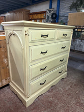 Load image into Gallery viewer, Classic French style chest of drawers in soft cream / white tones. Features a practical layout with two short drawers above three deep drawers, all dovetail jointed for durability. Generous storage capacity suits both elegant and country interiors. Pre-loved piece with gentle patina and character marks that add authentic vintage appeal.

Delivery Available

Overall Dimensions

107cm wide x 49cm deep x 104cm high

