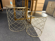Load image into Gallery viewer, A practical pair of wire-framed side tables with glass tops, offering both durability and functionality. Each table shows honest signs of use with minor surface marks, yet remains in solid working condition. The clever stacking design makes them ideal for compact spaces or convenient storage when not in use.

Delivery Available

Overall Dimensions

Biggest table : 41cm diameter x 51cm high&nbsp;

