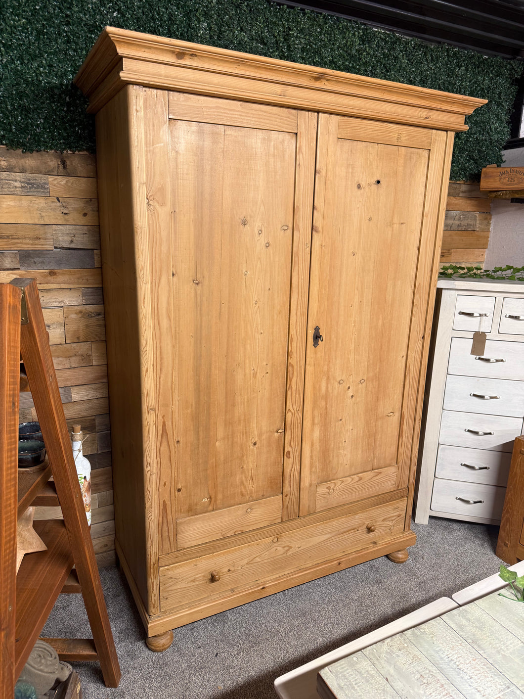 This beautiful antique pine wardrobe is solidly built and well-preserved considering its age. While it shows some minor signs of wear, these don’t affect its charm. It offers generous storage with a hanging rail, a shelf, and a spacious dovetail-jointed drawer. For convenience, it can be fully dismantled to simplify moving and includes a key for secure use.

Overall Dimensions

131.5cm wide x 59cm deep x 192cm high

DELIVERY AVAILABLE      

For our other items see our website https://fossewayfurniture.co.u