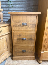 Load image into Gallery viewer, A charming rustic tallboy with authentic character and solid construction. This three-drawer tallboy / filing cabinet offers generous storage space and is in good working order. Light wear and patina add to its vintage appeal, making it a practical and stylish addition to any room.

Delivery Available

Overall Dimensions

62cm wide x 56cm deep x 116cm high

