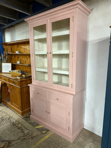 This charming tall dresser in baby pink was painted by its previous owners and might benefit from a fresh coat of paint. It provides plenty of storage with three shelves at the top, two drawers below, and a double cupboard with a long shelf inside. For convenience, it separates into two parts to make moving easier.

Overall Dimensions

150cm wide x 46cm deep x 220cm high

DELIVERY AVAILABLE      

For our other items see our website https://fossewayfurniture.co.uk

collection from our shop at cv36, our coll