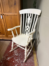 Load image into Gallery viewer, Charming solid pine rocking chair with authentic character. Structurally sound and ready to use, this fireside favourite bears the gentle patina of age—light surface marks and paint chips add to its vintage appeal. A timeless statement piece that brings warmth and movement to any room.

Delivery Available

Overall Dimensions

approx : 66cm wide x 48cm seat depth x 117cm high


