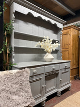 Load image into Gallery viewer, A charming vintage pine dresser with authentic character and practical storage. This piece features two shelves in the top section above three dovetail-jointed drawers, and three cupboards in the base section. Currently finished in grey with natural wear marks that add to its vintage appeal—ideal for refinishing to suit your décor. Separates into two parts for convenient transport and repositioning. A versatile statement piece for any room.

Delivery Available

Overall Dimensions

163cm wide x 46cm deep x 1
