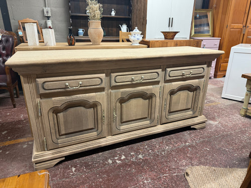 Discover the timeless appeal of this beautifully restored oak sideboard, returned to its authentic natural finish. With generous storage across three drawers and two spacious cupboards—each featuring internal shelving—this piece offers practical elegance for any room. The original key is included, and the solid construction promises years of reliable use. A protective wax finish will enhance its character and durability, making it a wonderful addition to homes that appreciate quality craftsmanship and endur