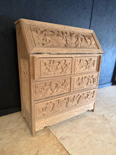Load image into Gallery viewer, This heavily carved oriental oak bureau showcases authentic craftsmanship with its intricate detailing and solid construction. Stripped back to reveal the natural wood grain, it features a pull-down writing desk with four short dovetail-jointed drawers and one long drawer beneath—ideal storage for a home office or landing space. The bare wood finish offers character and warmth, though we recommend applying a protective coat of wax to enhance durability and lustre. A truly distinctive statement piece that co
