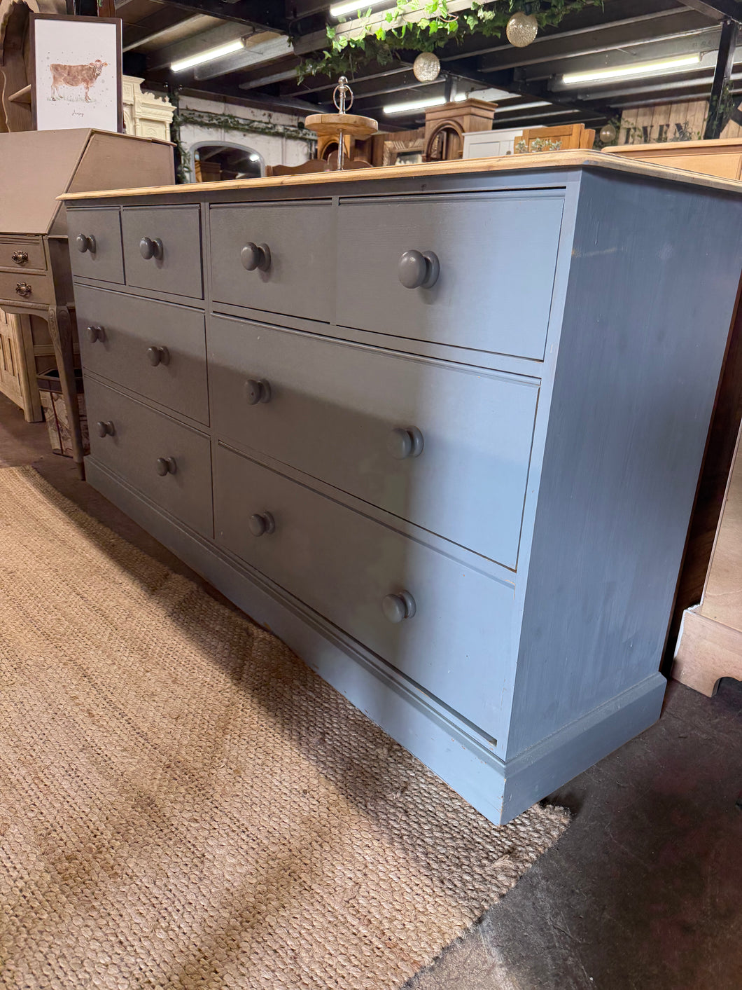This gorgeous wide solid pine chest of drawers features a grey paint finish from its previous owners, which could use a fresh coat or some touch-up work. It offers plenty of storage with 4 smaller dovetail jointed drawers stacked above 4 larger ones.

Delivery Available

Overall Dimensions

184cm wide x 43cm deep x 89.5cm high  
