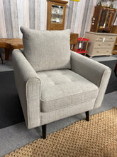 Load image into Gallery viewer, This stunning grey armchair, nearly new and structurally sound, offers both style and comfort to your living space. Its soft grey upholstery complements a variety of decor styles, while the sturdy frame ensures lasting durability. For added convenience, the legs can be easily removed, making it simple to move or transport. Perfect for relaxing with a book or adding a cozy touch to any room, this armchair combines practicality with elegant design

Overall Dimensions

approx : 78cm wide x 81cm deep x 91cm hig
