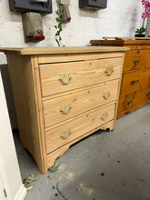 Load image into Gallery viewer, This impressive stripped pine chest of drawers is sturdy and in great condition overall. It has been fully stripped down to its natural wood and may require a layer of wax for preservation. This piece boasts three spacious dovetail jointed drawers for storing your belongings. While it once had a superstructure on top, there are some holes present, but they do not impact its use.

Overall Dimensions

91.5cm wide x 47cm deep x 79cm high

DELIVERY AVAILABLE      

For our other items see our website https://fo
