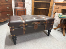 Load image into Gallery viewer, This distinctive leather pouffe combines functionality with timeless style. Built to last, it features a sturdy construction and lift-up lid that opens to generous hidden storage—perfect for blankets, cushions, or out-of-season items. The worn patina adds character and authenticity to any room. A versatile piece that works as extra seating, a footrest, or a stylish storage solution.

Delivery Available

Overall Dimensions

81cm wide x 41cm deep x 43cm high
