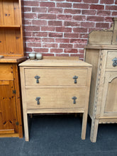 Load image into Gallery viewer, Beautifully stripped back to its natural finish, this oak chest of drawers showcases authentic wood grain and craftsmanship. Features two dovetail-jointed drawers offering sturdy, lasting storage. The bare oak finish invites personalisation — a coat of wax or oil will enhance protection and deepen the wood's character. Structurally sound and ready to complement any room with timeless appeal.

Delivery Available

Overall Dimensions

61cm wide x 41cm deep x 77cm high


