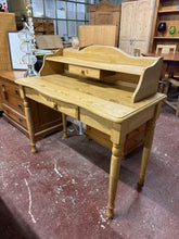 Load image into Gallery viewer, A charming pine dressing table that combines practicality with timeless appeal. This well-maintained piece features sturdy construction and authentic character from its pre-loved history. The detachable superstructure offers flexibility to suit your space, while two generous drawers provide convenient storage for your essentials. Minor surface marks only add to its vintage charm and do not detract from its use.

Overall Dimensions

102cm wide x 48.5cm deep x 96.5cm high

DELIVERY AVAILABLE      

For our ot
