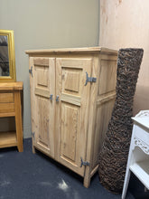 Load image into Gallery viewer, Solid pine storage cupboard, stripped to natural wood and ready for waxing. Features one internal shelf with space to add more shelving as needed. Structurally sound and in good condition. A coat of wax or oil will enhance protection and bring out the wood's character. Ideal for those seeking authentic, customisable storage with genuine craftsmanship.

Delivery Available

Overall Dimensions

89cm wide x 63cm deep x 124cm high

