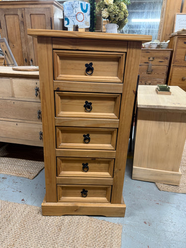 This sturdy solid pine tallboy is well-built and in good overall shape. While it is pre-owned and shows a few minor marks, there’s nothing significant. It features five small drawers, perfect for extra storage.

Delivery Available

Overall Dimensions

53cm wide x 39cm deep x 104cm high 
