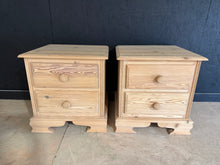 Load image into Gallery viewer, A charming pair of stripped pine bedside tables, restored to their natural wood finish. Each unit features two practical drawers for convenient storage. The natural grain and warm patina make these versatile pieces ideal for traditional or contemporary interiors. Minor surface variations are characteristic of authentic pine. A protective wax finish is recommended to enhance durability and bring out the wood's natural beauty. Structurally sound and ready to enhance your bedroom.

Delivery Available

Overall 
