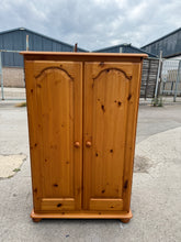 Load image into Gallery viewer, This sturdy pine child&#39;s wardrobe is in good overall shape. While it shows some signs of use with minor marks, they are not very noticeable. Inside, it features a single hanging rail, perfect for organising clothes.

Overall Dimensions

81cm wide x 56cm deep x 126cm high

DELIVERY AVAILABLE      

For our other items see our website https://fossewayfurniture.co.uk

collection from our shop at cv36, our collection zone at bs36 or otherwise delivery is available

