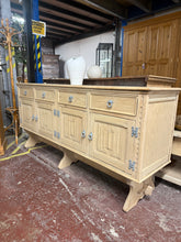 Load image into Gallery viewer, This impressive large oak sideboard showcases beautiful natural wood grain after being stripped back to bare timber. The piece combines practical storage with traditional craftsmanship, featuring four dovetail-jointed drawers and two spacious cupboards—one fitted with an internal shelf. Structurally sound and in excellent condition, it's ready for finishing with wax or oil to enhance and protect the wood. A versatile statement piece for any dining room or hallway.

Delivery Available

Overall Dimensions

18
