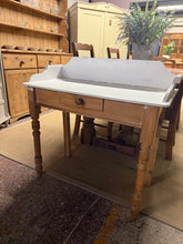 Load image into Gallery viewer, A charming pine washstand in solid, functional condition. This piece features authentic character with minor surface marks that add to its vintage appeal—ideal for refinishing or using as-is. Single front drawer provides practical storage. Versatile enough for bathroom use, bedroom, or hallway. A wonderful foundation for restoration or immediate use.

Delivery Available

Overall Dimensions

88cm wide x 42cm deep x 72cm / 89cm high

