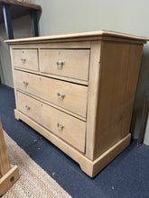 Load image into Gallery viewer, Authentic stripped oak chest of drawers with natural character. Features two short dovetail-jointed drawers over two long drawers, providing generous storage capacity. Returned to bare wood finish—ideal for customising with your choice of stain or wax. Shows honest wear consistent with vintage pieces. A versatile addition to bedroom or living spaces.

Delivery Available

Overall Dimensions

106.5cm wide x 50cm deep x 79cm high

