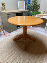 Load image into Gallery viewer, A charming round wooden dining table with timeless appeal. This sturdy piece comfortably seats four and features detachable legs for convenient transport and storage. Well-maintained with the natural patina of gentle use, it brings warmth and character to any dining space. Perfect for intimate meals and gatherings.

Delivery Available

Overall Dimensions

91cm diameter x 75cm high

