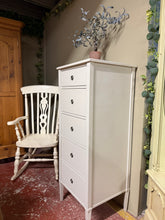 Load image into Gallery viewer, Discover this elegant light grey Laura Ashley tallboy—a timeless piece with genuine character. Featuring five spacious drawers, it offers practical storage for bedroom essentials while maintaining the refined aesthetic Laura Ashley is renowned for. The piece is structurally sound and well-maintained. As a pre-loved item, it bears the natural patina of use—subtle marks that speak to its history rather than detract from its appeal. Originally retailing at over £650, this is an exceptional opportunity to own a
