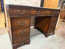 Load image into Gallery viewer, This beautiful Edwardian mahogany double pedestal desk is sturdy and generally well maintained. While it shows some minor signs of wear, they are hardly noticeable. The desk offers plenty of storage with eight short drawers featuring dovetail joints and one long drawer. It also breaks down into three parts, making it easier to move.

Delivery Available

Overall Dimensions

122cm wide x 61cm deep x 75cm high

