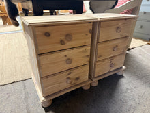 Load image into Gallery viewer, This charming pair of pine bedsides has been fully stripped to reveal the natural wood, making them perfect for adding a protective wax finish. Each bedside features three small drawers, ideal for keeping your essentials neatly tucked away.

Delivery Available

Overall Dimensions

44cm wide x 39cm deep x 59cm high&nbsp;

