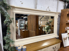 Load image into Gallery viewer, A beautiful cream over mantle mirror that brings elegance to any fireplace setting. This generously sized piece is built to last, with solid construction and excellent overall condition. While it bears the gentle patina of age with minor surface marks, these only add to its authentic character and charm. Perfect for creating a focal point above your mantelpiece.

Delivery Available

Overall Dimensions

168cm wide x 11cm deep x 89cm high&nbsp; &nbsp;

