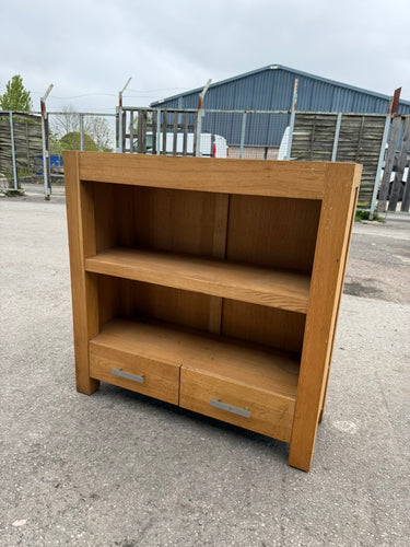 With a structurally sound build and in overall good condition, this sturdy oak bookcase is sure to stand the test of time. And despite some minor marks, it offers ample storage with 1 shelf and 2 dovetail jointed drawers. Perfect for organizing any space.

Overall Dimensions

90cm wide x 32.5cm deep x 91cm high

DELIVERY AVAILABLE      

HAVE THIS PAINTED A COLOUR OF YOUR CHOICE FOR AN EXTRA £80 OR HAVE IT COMPLETELY STRIPPED BACK FOR JUST £100    

For our other items see our website https://fossewayfurnit